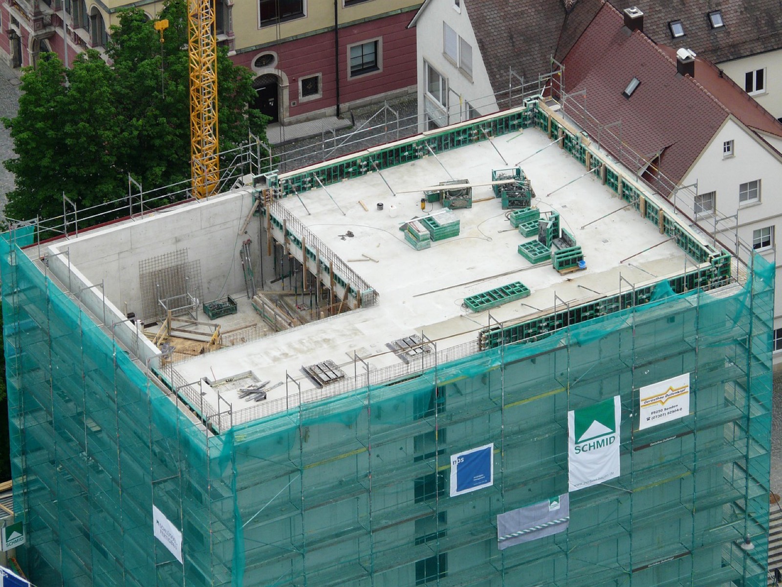 Immeuble résidentiel en construction entouré de grues